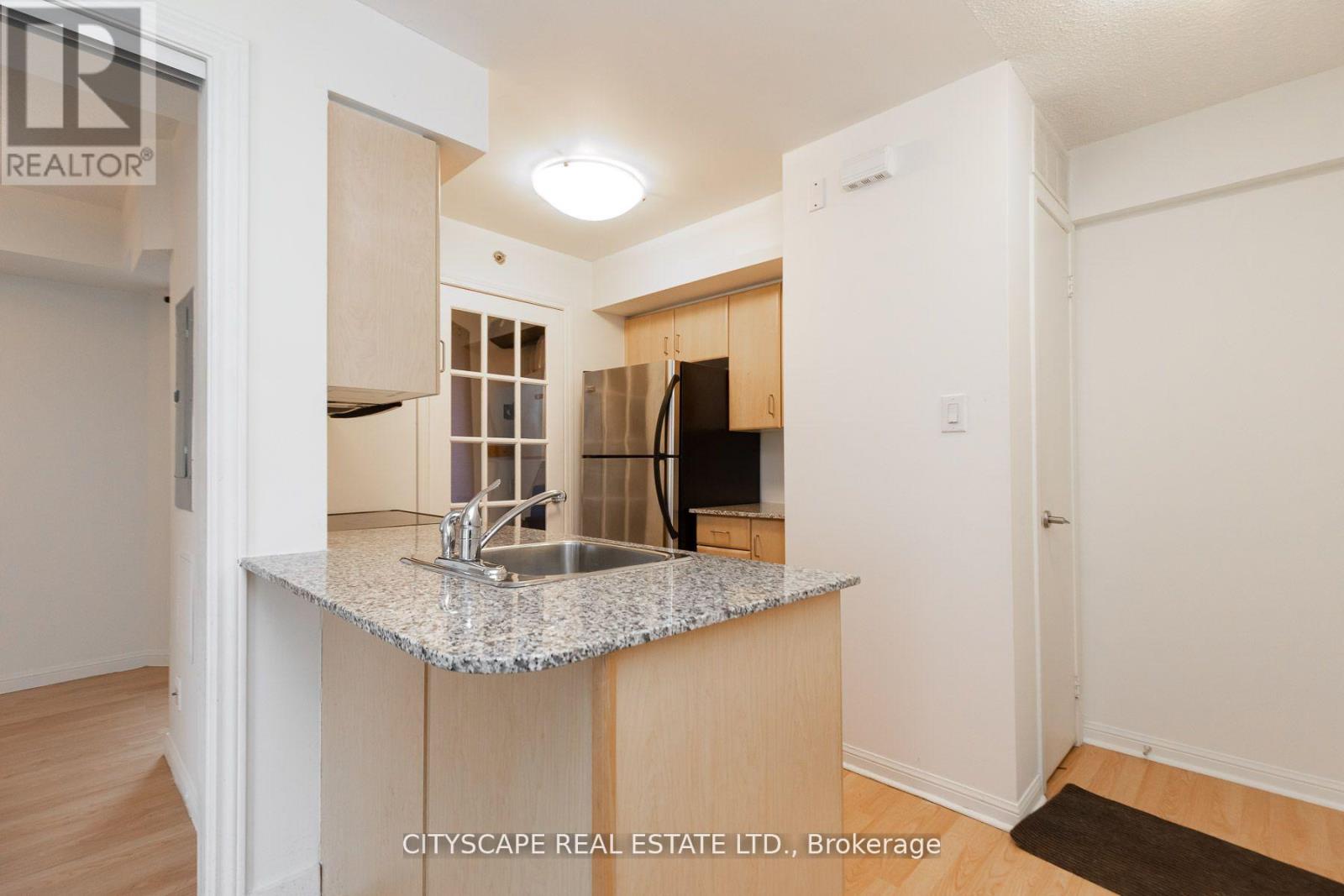 A kitchen with granite countertops and a sink.