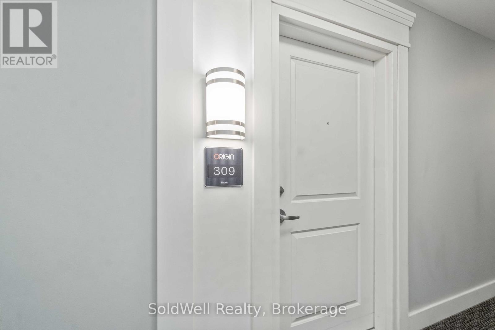 A white door with a keypad on the wall above it.