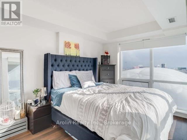 A bedroom with a large bed and a view of the city.