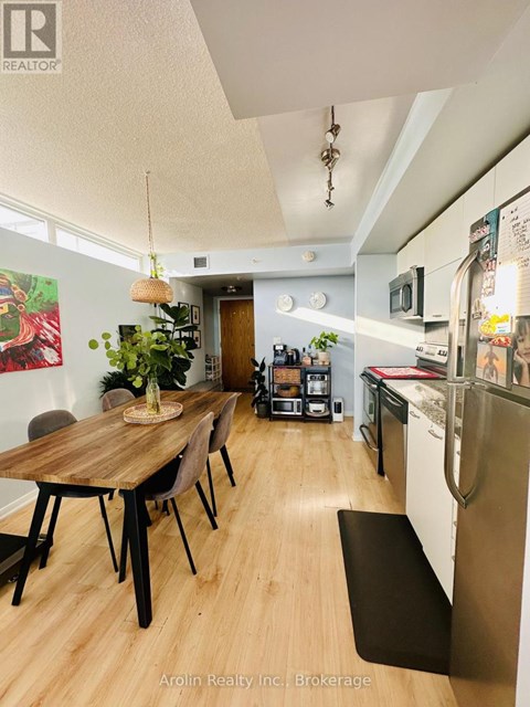 A kitchen with a table and chairs in the middle of the room.