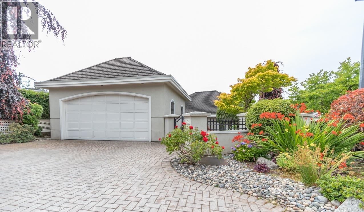 A house with a driveway and a garden in front.