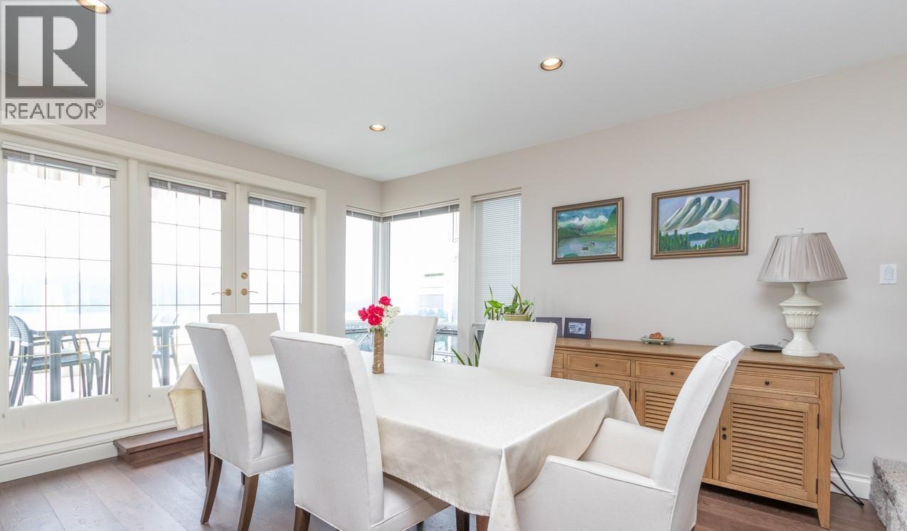 A dining room with a table set for four.
