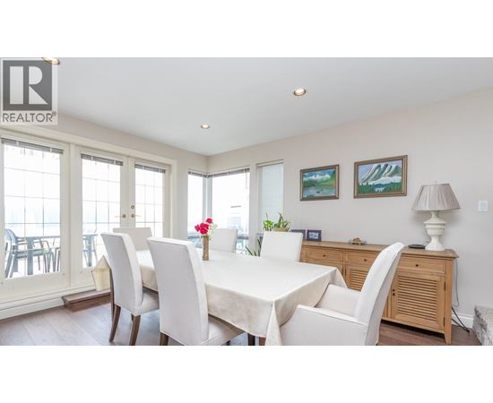 A dining room with a table set for four.