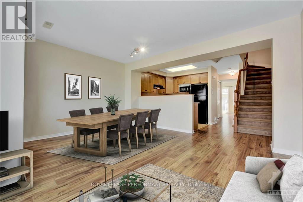 A dining room with a wooden table and chairs.
