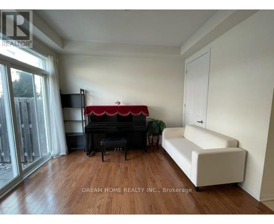 A living room with a red couch and a white sofa.