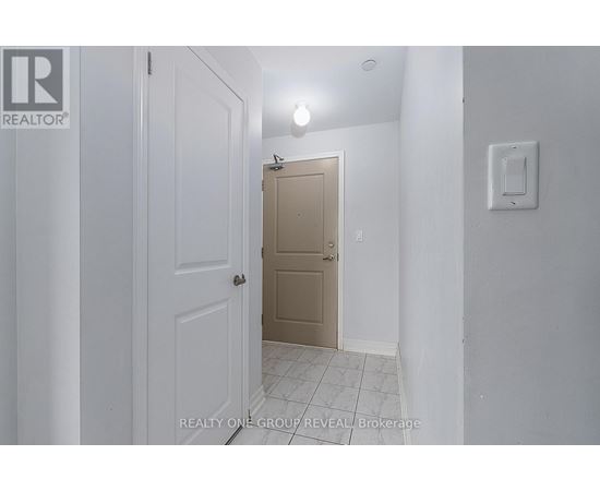 A hallway with a white door on the left and a beige door on the right.