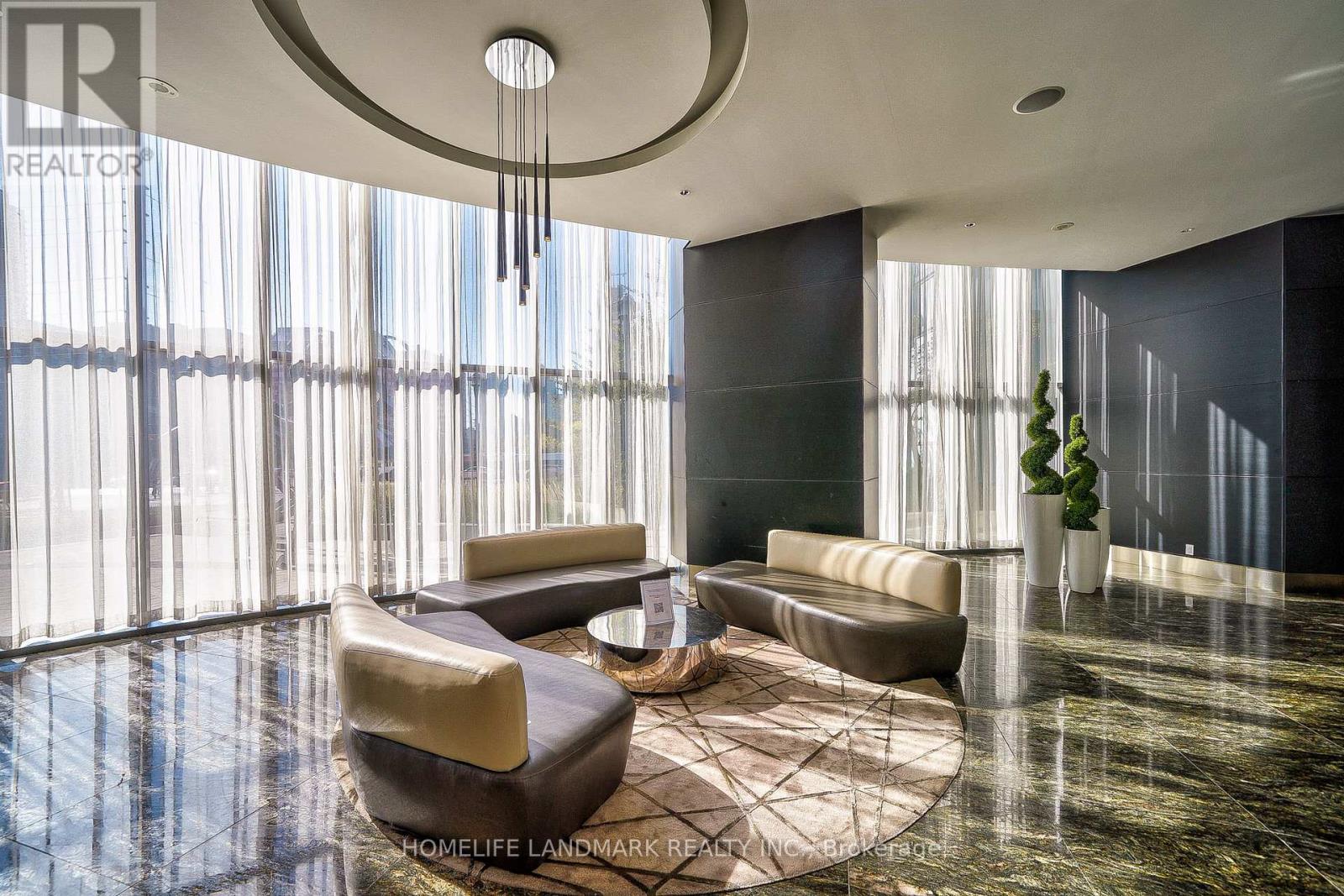 A large, modern living room with a circular ceiling and a large window.