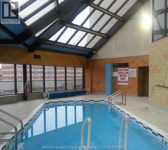 A pool with a sign that says "Caution Water Shallow No Diving".