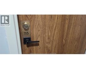 A door with a lock and a number plate on it.