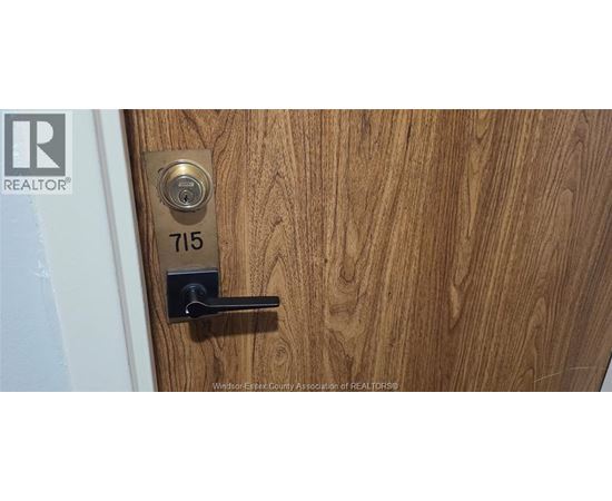 A door with a lock and a number plate on it.