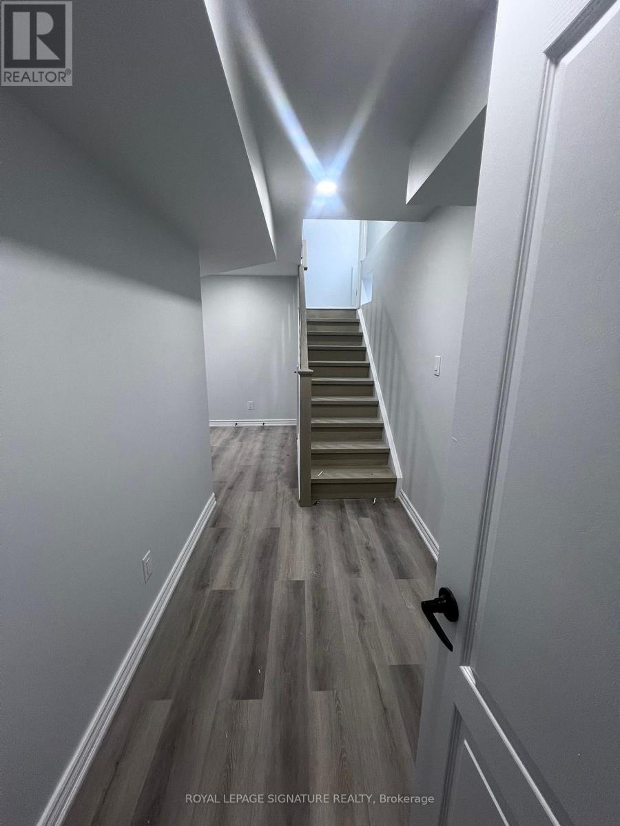 A hallway with a staircase leading to the second floor.