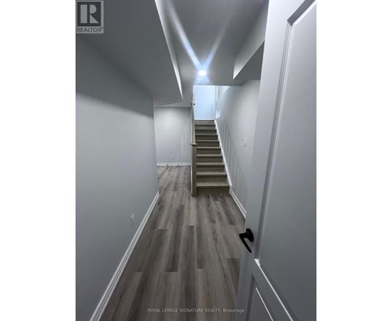 A hallway with a staircase leading to the second floor.