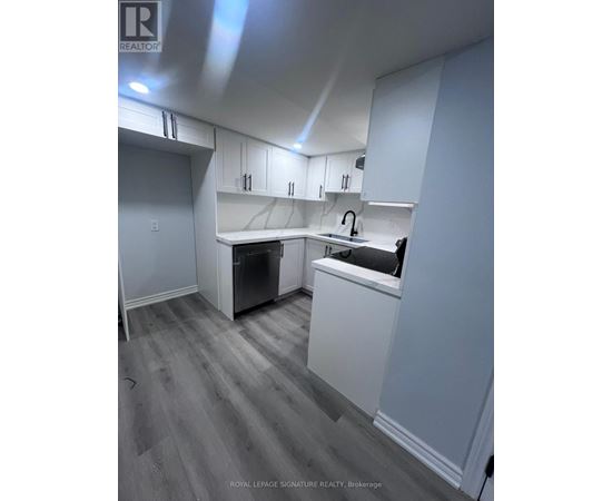 A kitchen with white cabinets and a dishwasher.