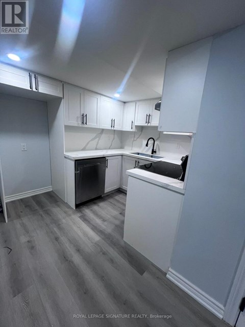 A kitchen with white cabinets and a dishwasher.