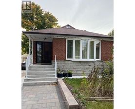 A small house with a porch and a front yard.