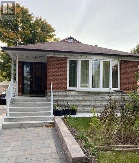 A small house with a porch and a front yard.