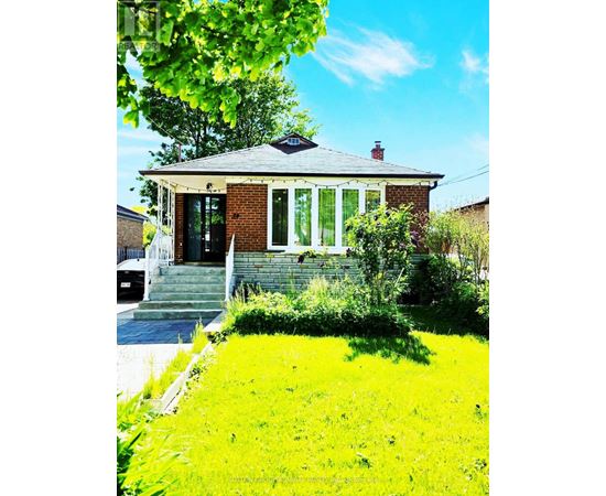 A small house with a green lawn in front.
