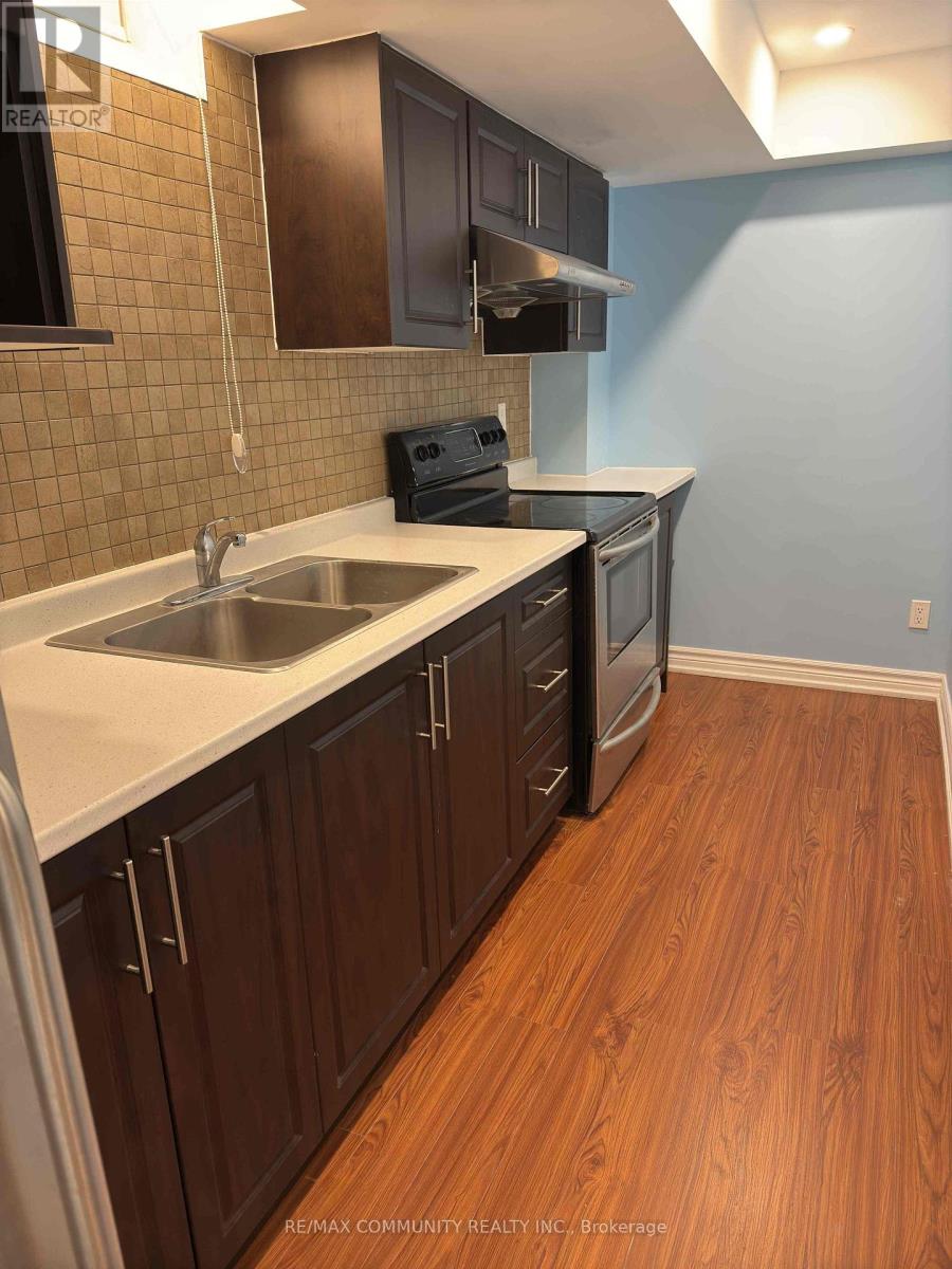 A kitchen with wooden cabinets and a white counter top.