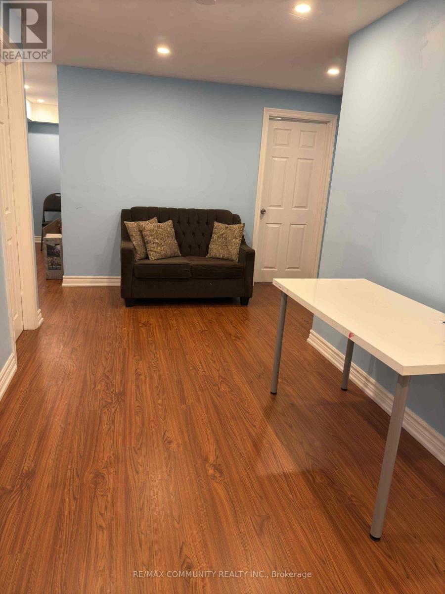 A brown couch sits in a room with a white table.