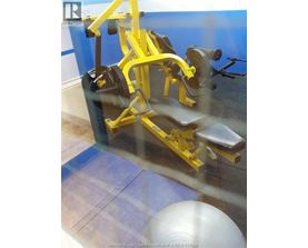 A yellow gym machine is in the foreground of the image.