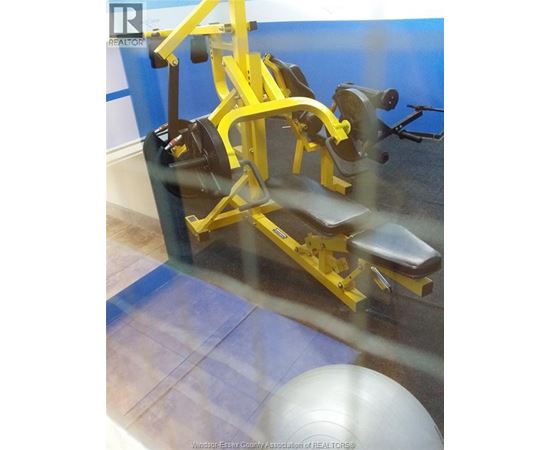 A yellow gym machine is in the foreground of the image.