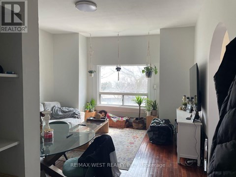 A living room with a couch, chair, and a table with a glass top.