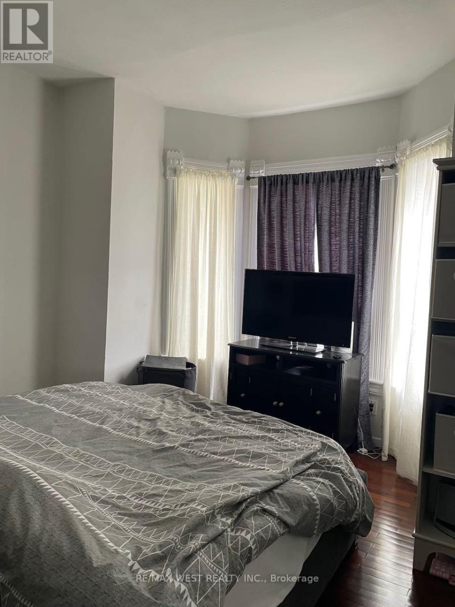 A bedroom with a large bed and a flat screen TV.