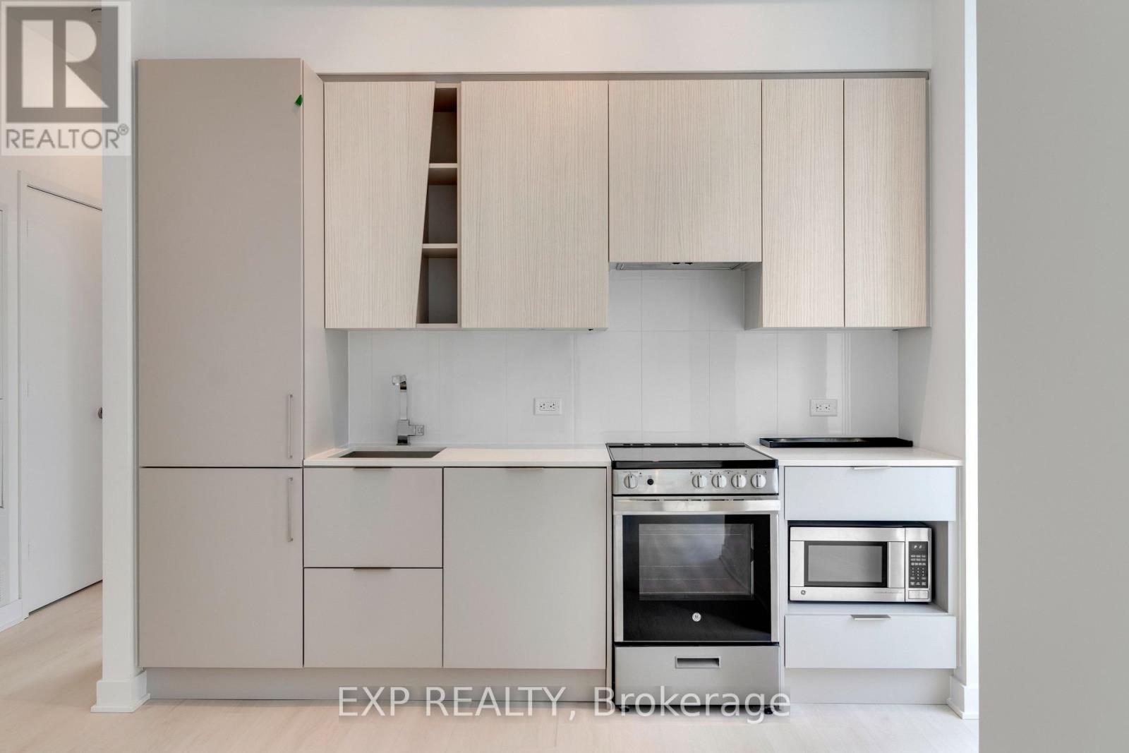 A kitchen with white cabinets and appliances.