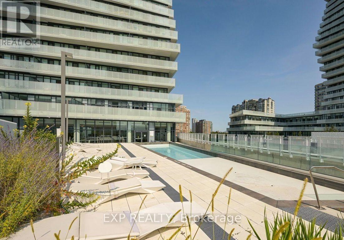 A modern building with a pool in front of it.