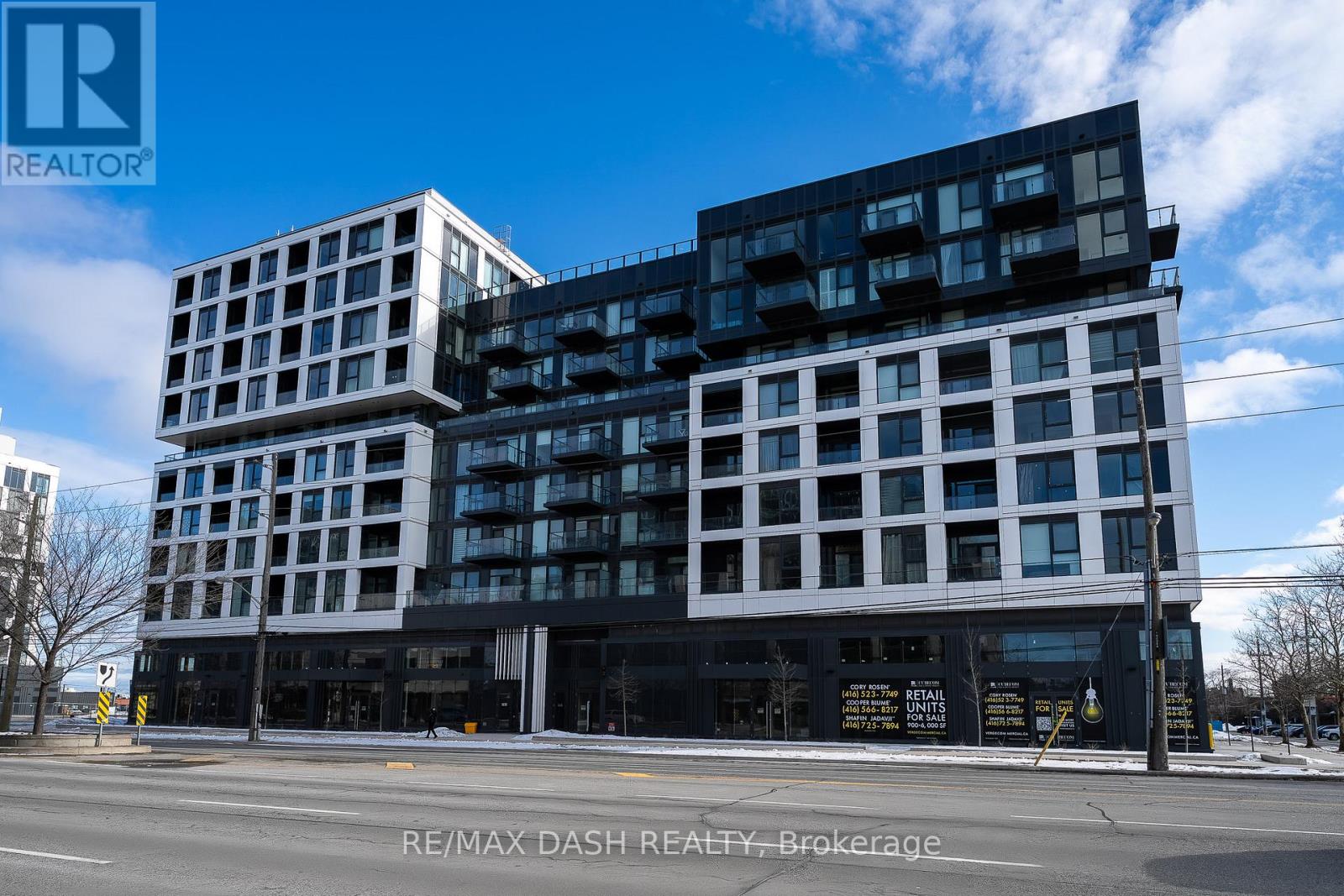 A modern multi-story building with a black and white facade.