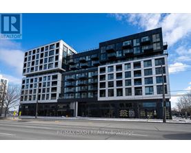 A modern multi-story building with a black and white facade.