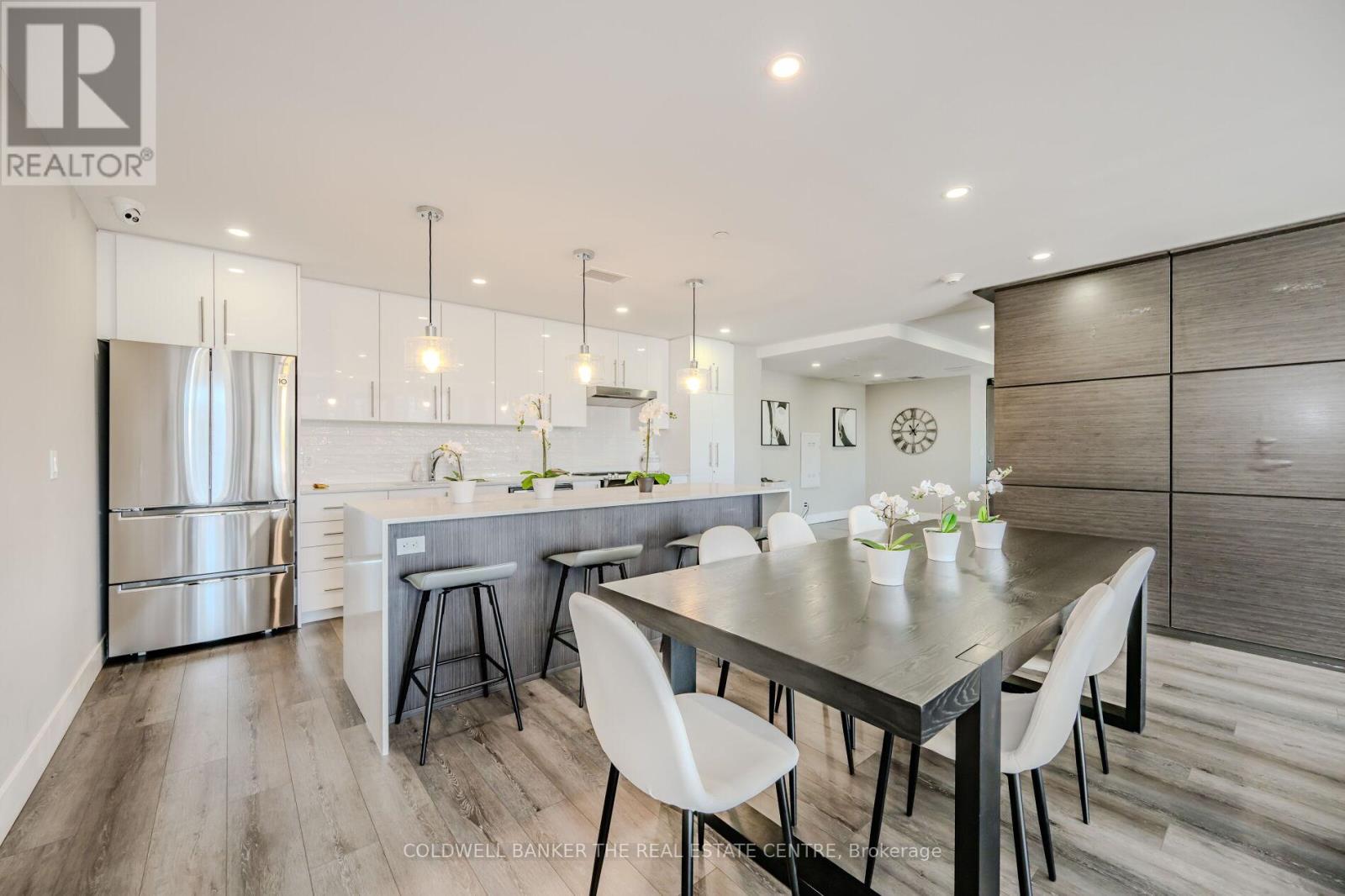 A modern kitchen with a dining table and chairs.