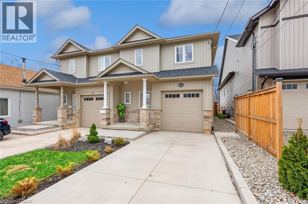 A large, two-story house with a garage is for sale.