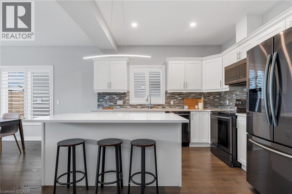 A modern kitchen with white cabinets and a large island.
