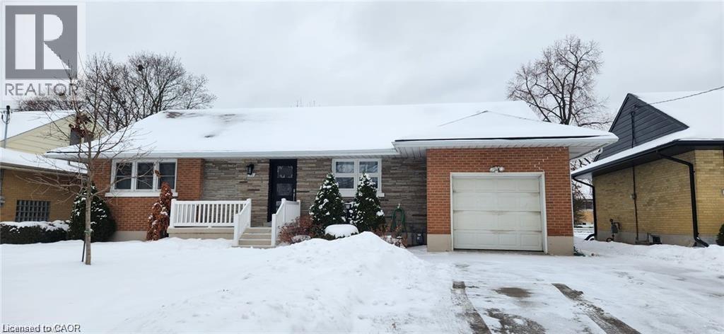 A house with a snow-covered front yard.