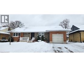 A house with a snow-covered front yard.