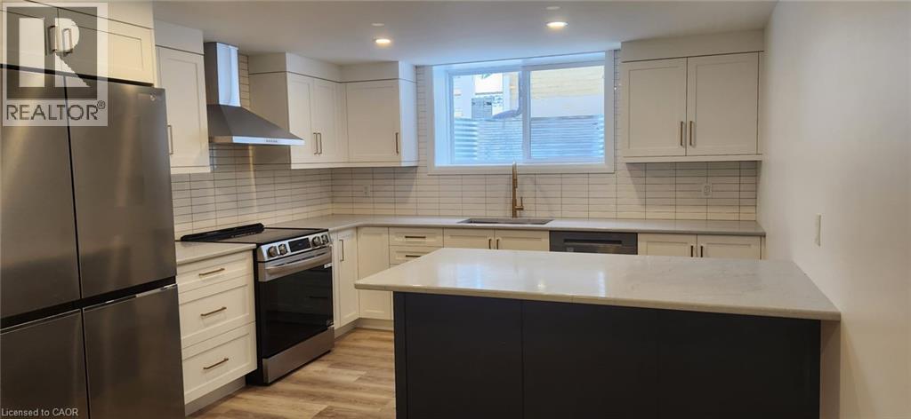 A kitchen with a refrigerator, stove, and oven.