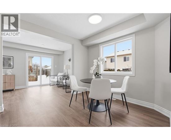 A dining room with a table set for four.