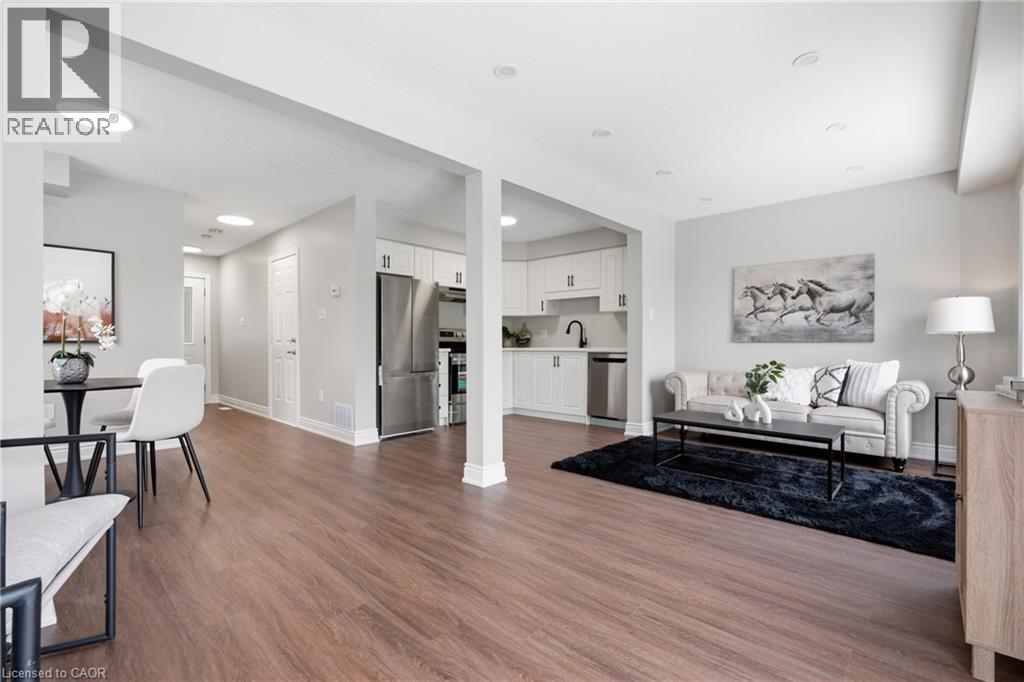A modern living room with a dining table and chairs.