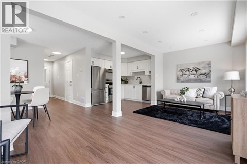 A modern living room with a dining table and chairs.