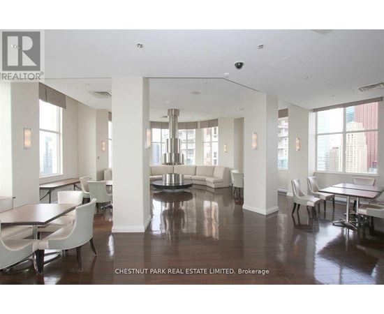 A spacious living room with a dining table and chairs.