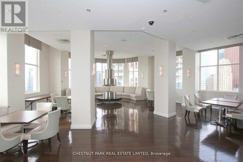 A spacious living room with a dining table and chairs.