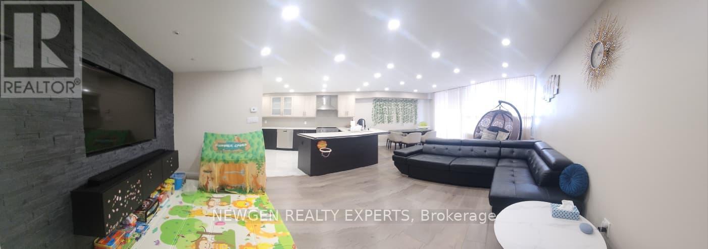 A living room with a flat screen TV and a couch.