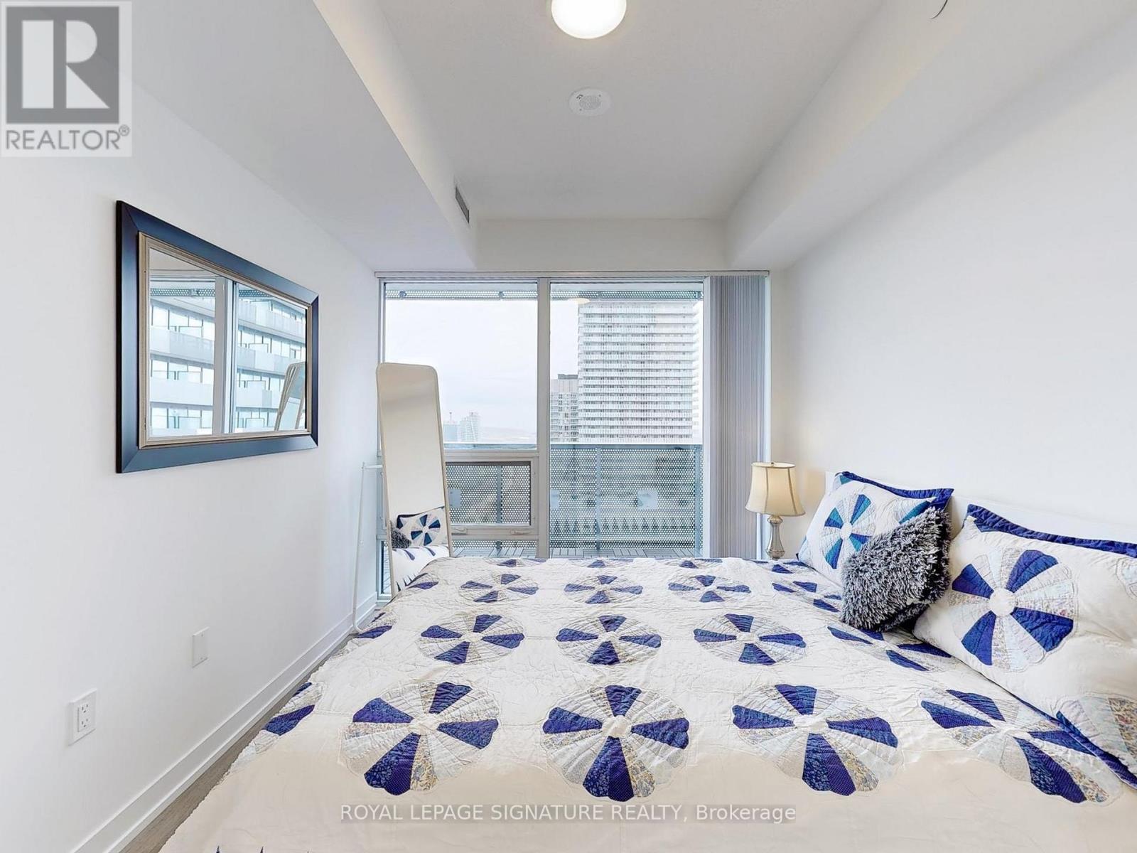 A bedroom with a bed and a window.