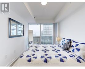 A bedroom with a bed and a window.