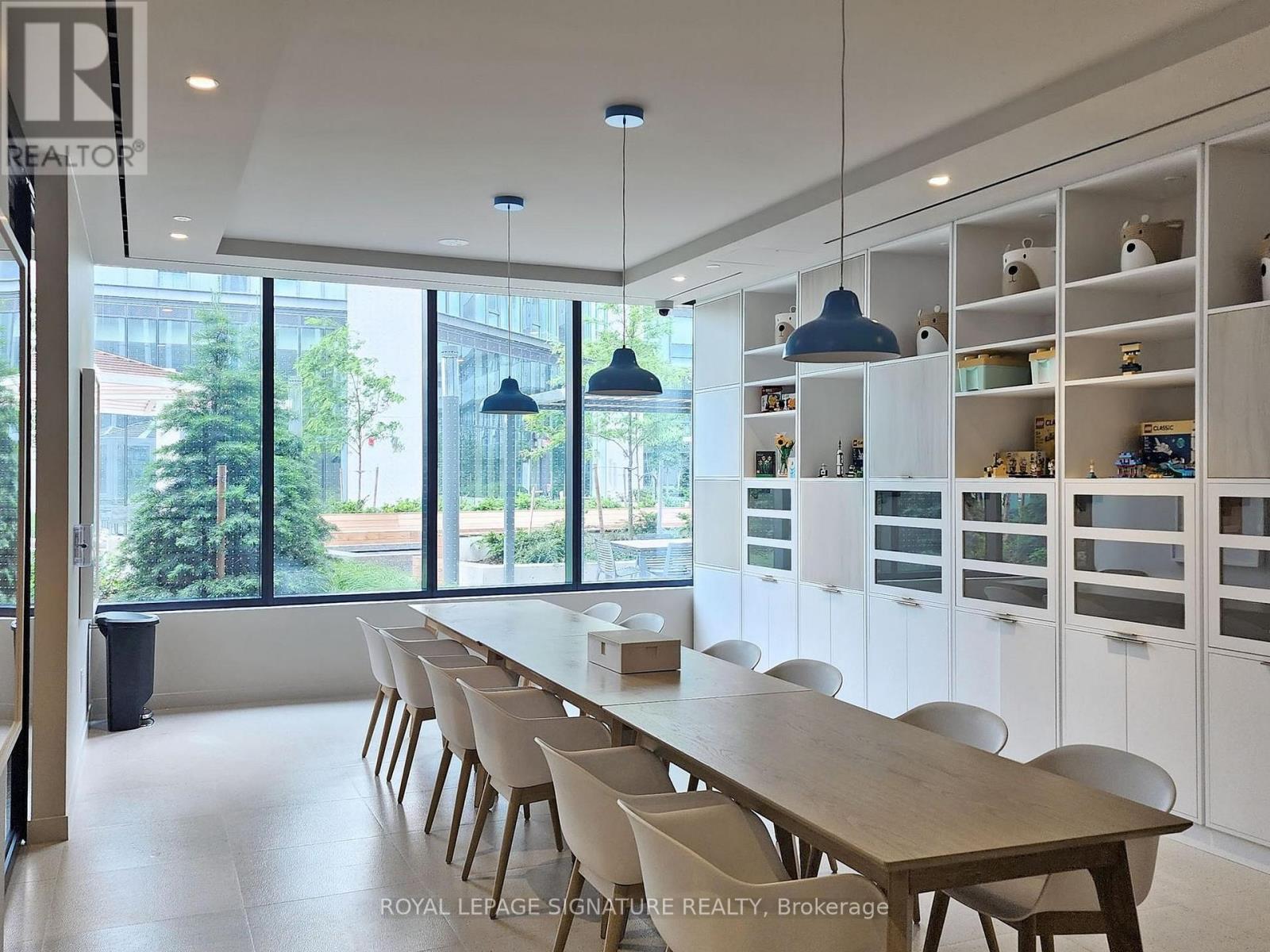 A dining room with a long table and chairs.