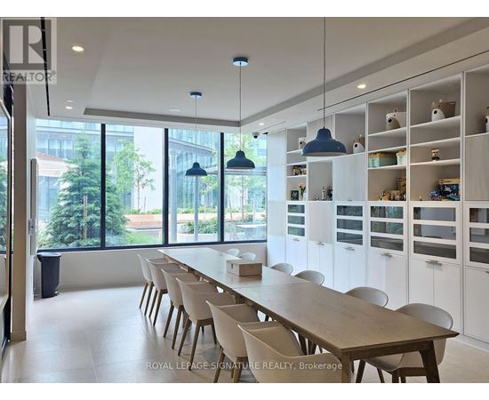 A dining room with a long table and chairs.