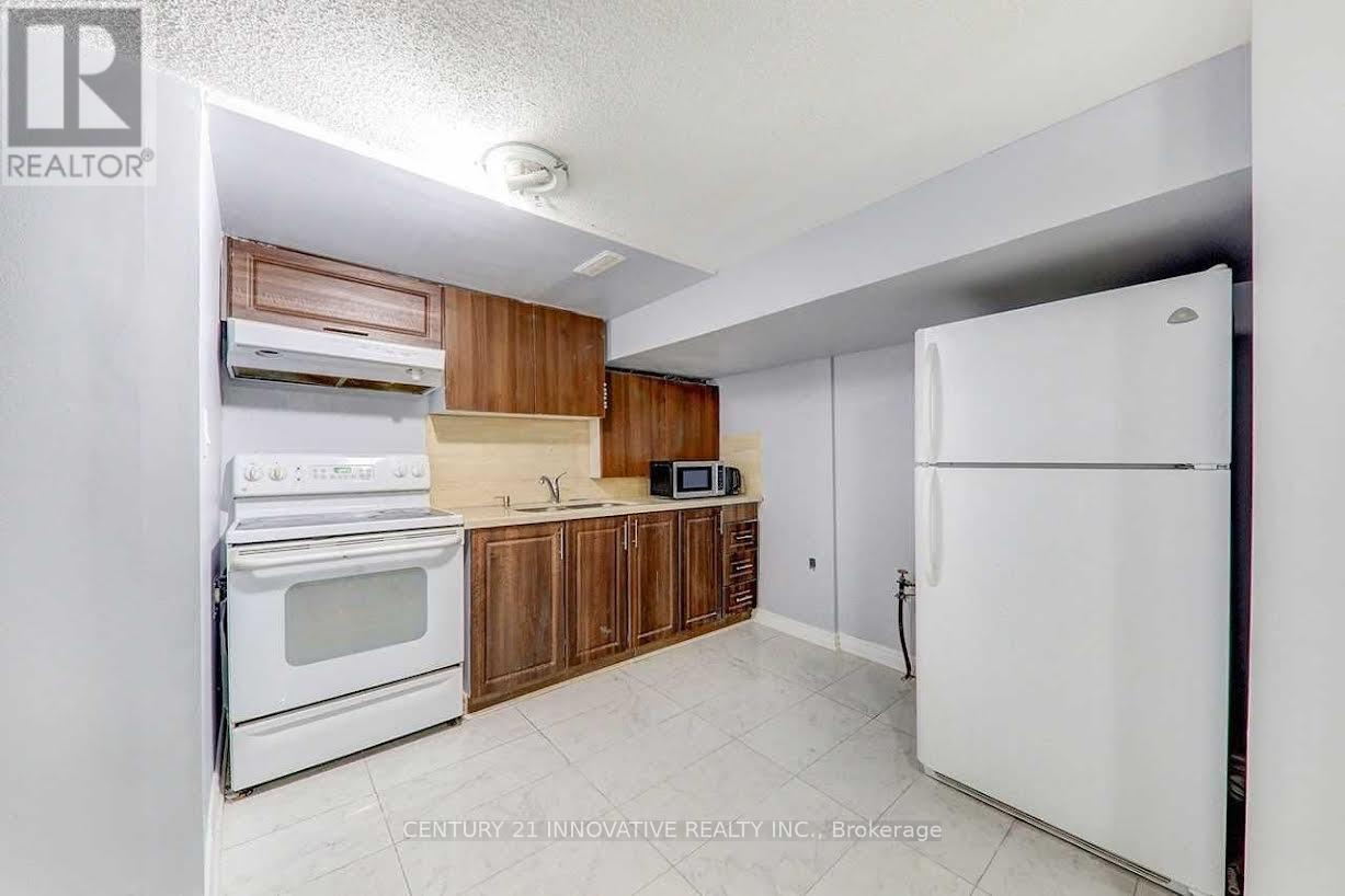A kitchen with white appliances and wooden cabinets.