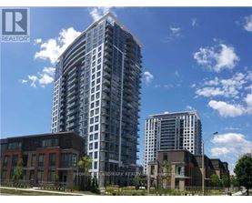 A tall residential building stands next to a shorter brick building.