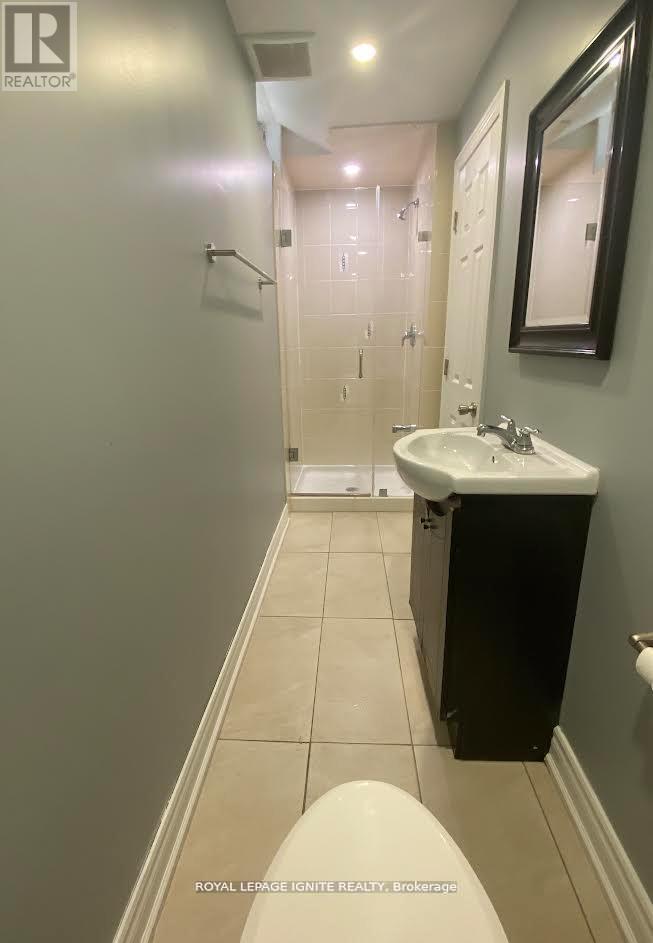 A bathroom with a sink, toilet and shower.